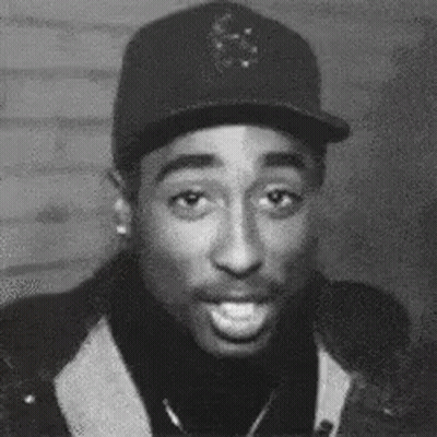 A Black And White Photo Of A Man Wearing A Hat And A Turtleneck . GIF