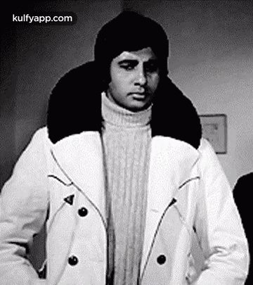 A Black And White Photo Of A Man Wearing A Hat And A White Coat . GIF