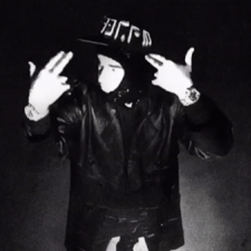 A Black And White Photo Of A Man Wearing A Hat That Says Dfm GIF