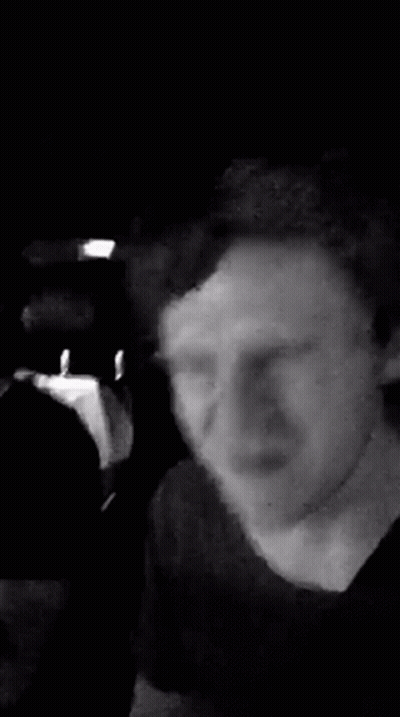 A Black And White Photo Of A Man Wearing A Headband And Smiling . GIF