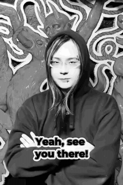 A Black And White Photo Of A Man Wearing A Hoodie And Glasses . GIF