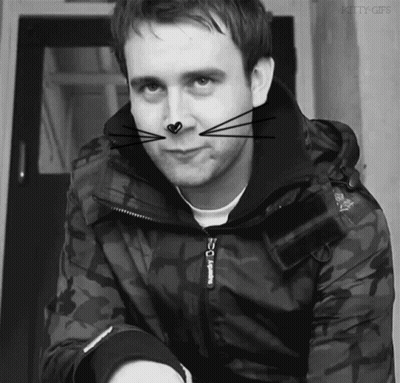 A Black And White Photo Of A Man Wearing A Jacket With The Word Superdry On It GIF