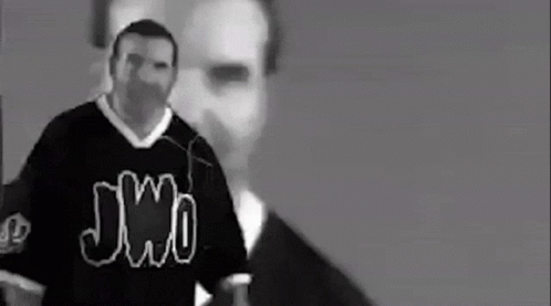 A Black And White Photo Of A Man Wearing A Jersey That Says Jmo . GIF