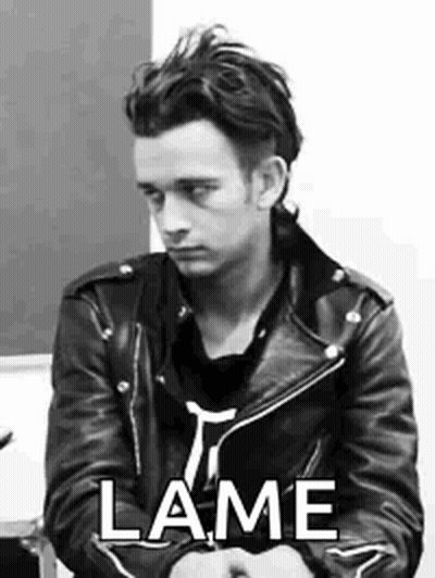 A Black And White Photo Of A Man Wearing A Leather Jacket And A Black Shirt . GIF