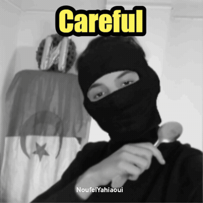 A Black And White Photo Of A Man Wearing A Mask With The Words Careful Written Above Him GIF
