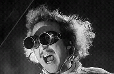A Black And White Photo Of A Man Wearing A Pair Of Goggles . GIF