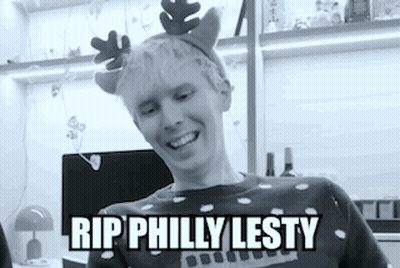 A Black And White Photo Of A Man Wearing A Reindeer Headband . GIF