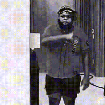 A Black And White Photo Of A Man Wearing A Shirt With The Letter S On It GIF