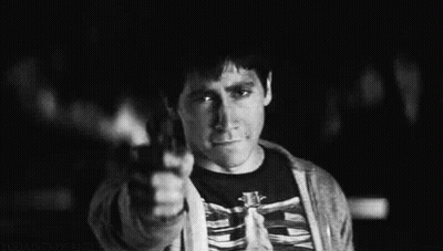A Black And White Photo Of A Man Wearing A Skeleton Shirt Giving The Middle Finger . GIF