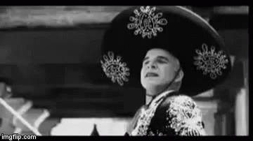 A Black And White Photo Of A Man Wearing A Sombrero And A Suit . GIF