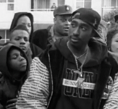 A Black And White Photo Of A Man Wearing A Sweatshirt That Says ' Runnin ' On It GIF