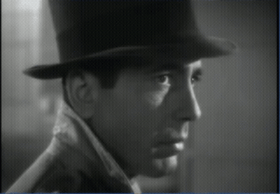 A Black And White Photo Of A Man Wearing A Top Hat And Coat GIF