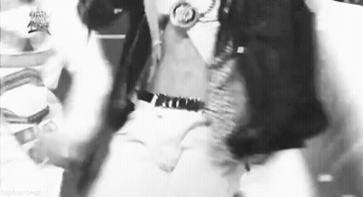A Black And White Photo Of A Man Wearing A Watch And A Hat . GIF