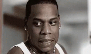 A Black And White Photo Of A Man Wearing A White Tank Top Making A Funny Face . GIF