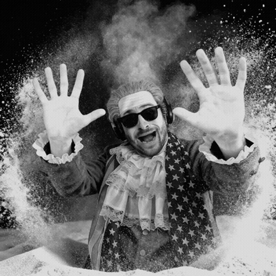 A Black And White Photo Of A Man Wearing A Wig And Sunglasses GIF