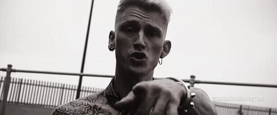 A Black And White Photo Of A Man Wearing Earrings And A Nose Ring . GIF