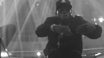 A Black And White Photo Of A Man Wearing Headphones And A Hat That Has The Letter B On It GIF