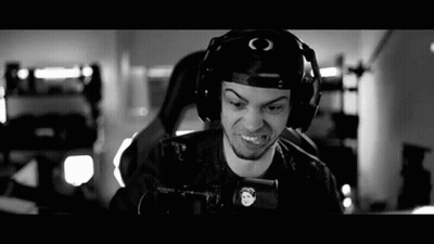 A Black And White Photo Of A Man Wearing Headphones And Holding A Gun . GIF