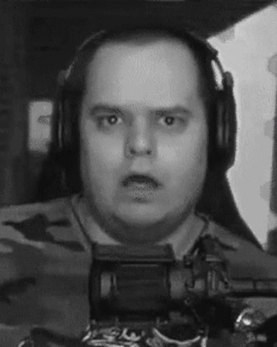 A Black And White Photo Of A Man Wearing Headphones And Looking At The Camera . GIF