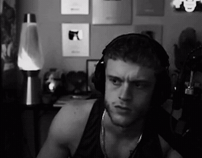 A Black And White Photo Of A Man Wearing Headphones In A Room . GIF