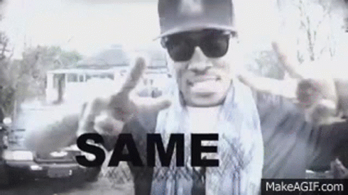 A Black And White Photo Of A Man Wearing Sunglasses And A Hat . GIF