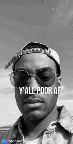 A Black And White Photo Of A Man Wearing Sunglasses And A Hat That Says Y All Poor Af GIF