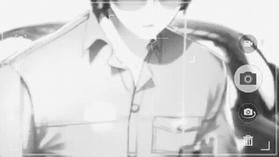 A Black And White Photo Of A Man Wearing Sunglasses And A Suit . GIF