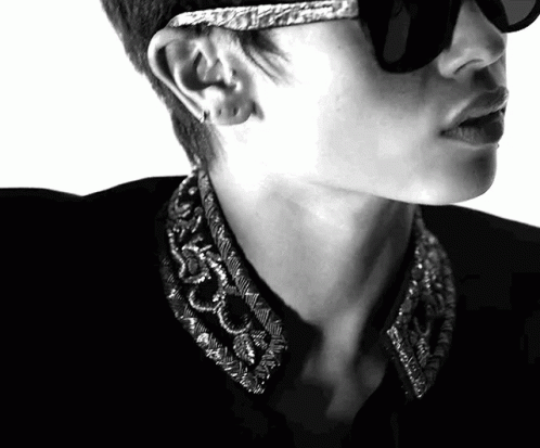 A Black And White Photo Of A Man Wearing Sunglasses And Earrings GIF