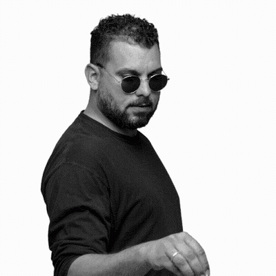 A Black And White Photo Of A Man Wearing Sunglasses And Waving His Hand GIF