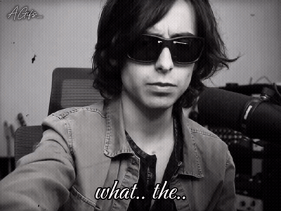 A Black And White Photo Of A Man Wearing Sunglasses With The Caption What The GIF