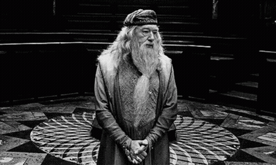 A Black And White Photo Of A Man With A Beard And A Hat Standing In A Circle . GIF