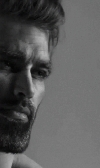 A Black And White Photo Of A Man With A Beard And A Serious Look On His Face . GIF