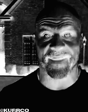 A Black And White Photo Of A Man With A Beard And A Shadow On His Face Taken By Kurrco GIF