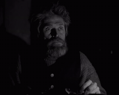 A Black And White Photo Of A Man With A Beard And Missing Teeth GIF