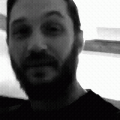 A Black And White Photo Of A Man With A Beard And Mustache . GIF
