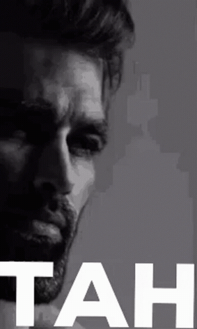 A Black And White Photo Of A Man With A Beard And The Word Tah In White Letters . GIF