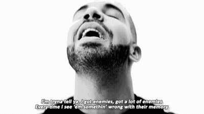 A Black And White Photo Of A Man With A Beard Making A Peace Sign With His Hands . GIF