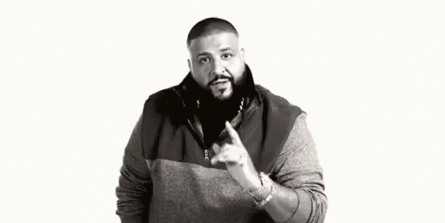 A Black And White Photo Of A Man With A Beard Pointing At Something . GIF