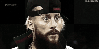 A Black And White Photo Of A Man With A Beard Wearing A Baseball Cap . GIF