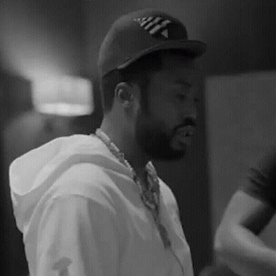 A Black And White Photo Of A Man With A Beard Wearing A Hat And Headphones . GIF