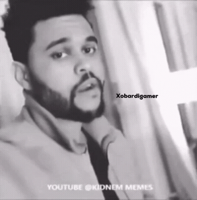 A Black And White Photo Of A Man With A Beard Wearing A Tie . GIF