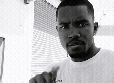 A Black And White Photo Of A Man With A Beard Wearing A White T-Shirt . GIF