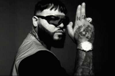 A Black And White Photo Of A Man With A Beard Wearing Sunglasses And A Watch GIF