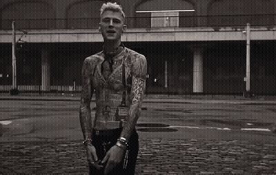 A Black And White Photo Of A Man With A Lot Of Tattoos On His Body GIF