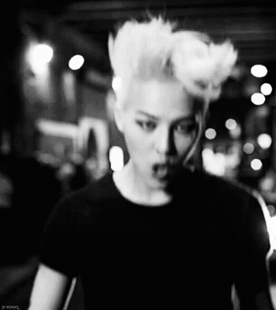 A Black And White Photo Of A Man With A Mohawk Hairstyle GIF