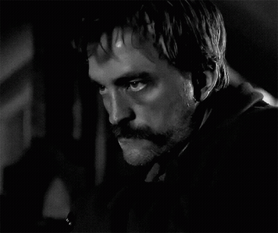 A Black And White Photo Of A Man With A Mustache And Beard GIF