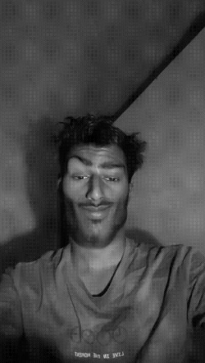 A Black And White Photo Of A Man With A Mustache Giving The Middle Finger GIF