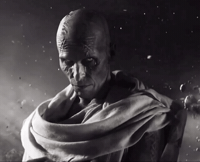 A Black And White Photo Of A Man With A Scarf Around His Waist GIF