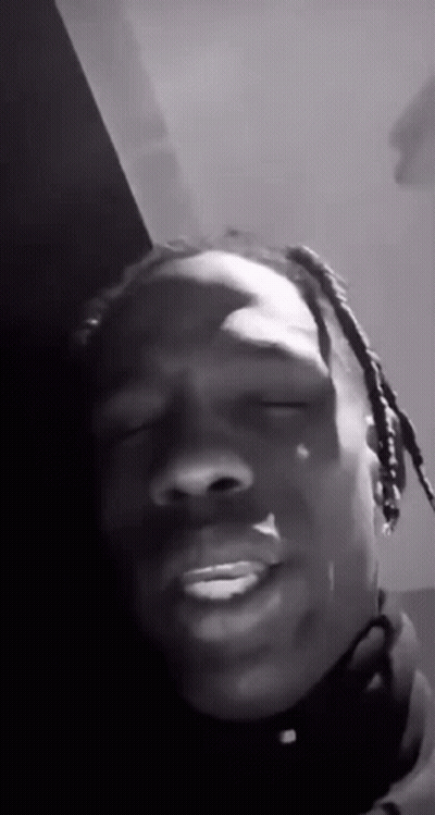 A Black And White Photo Of A Man With Dreadlocks Making A Funny Face With His Eyes Closed . GIF