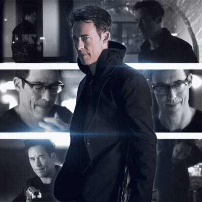 A Black And White Photo Of A Man With Glasses And A Black Jacket GIF